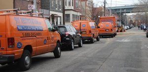 911-Restoration Water-Damage-Restoration-Vans-And-Trucks-Lined-Up-At-Urban-Job-Location New Orleans